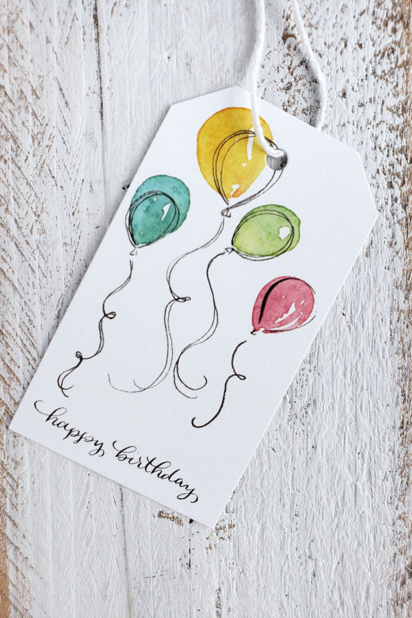 Birthday balloons gift tag with four balloons closeup