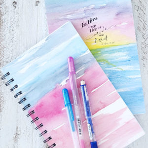 two art practice sketchbooks with watercolor covers