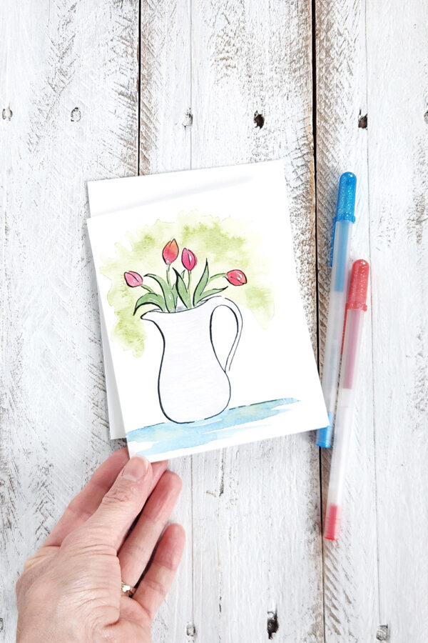tulips in a pitcher on a greeting card